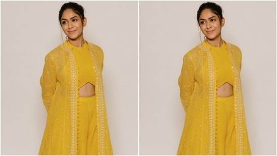 Mrunal decked up in a yellow cropped top with a closed halter neck and midriff-baring details.(Instagram/@mrunalthakur)