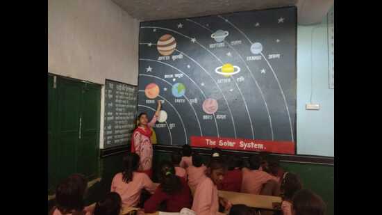 A science teacher taking class at a primary school in Prayagraj. (HT file) A science teacher taking class at a primary school in Prayagraj. (HT file)