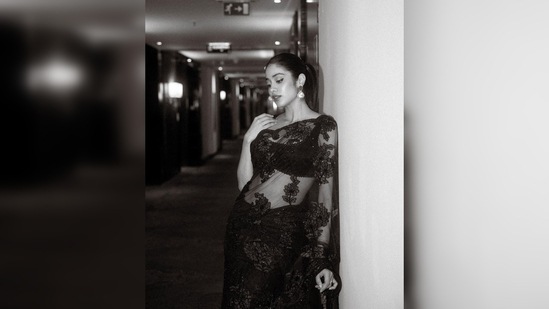Janhvi Kapoor looked like a retro queen in this gorgeous sequins see-through saree by one of India's most celebrated designers Manish Malhotra.(Instagram/@janhvikapoor)