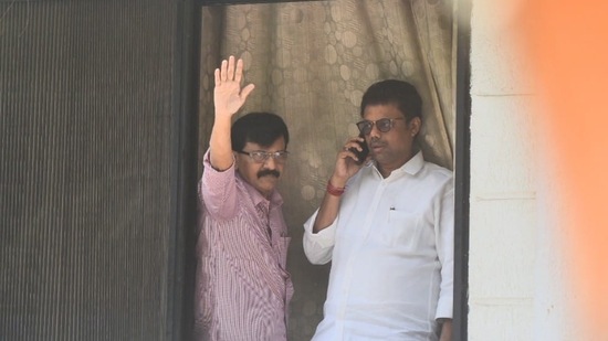 Shiv Sena leader Sanjay Raut waves at supporters as Enforcement Directorate officials conduct searches at his Mumbai residence.&nbsp;(Photo by Satish Bate)