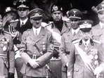 King Victor Emanuel III, Adolf Hitler and Benito Mussolini watch fascist troops march in central Rome in 1941 television file footage. Image via REUTERS