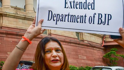 New Delhi: Shiv Sena MP Priyanka Chaturvedi holds a placard in protest against ED at Parliament House complex, during ongoing Monsoon Session, in New Delhi, Monday, (PTI) New Delhi: Shiv Sena MP Priyanka Chaturvedi holds a placard in protest against ED at Parliament House complex, during ongoing Monsoon Session, in New Delhi, Monday, (PTI)