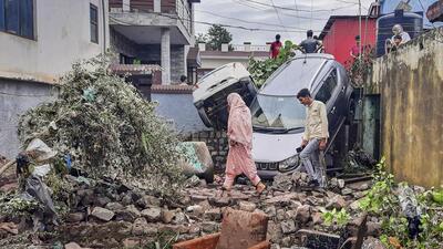 Locals walk amid damaged vehicles and property after flash floods in the Surankote area of Poonch on Monday. (PTI) Locals walk amid damaged vehicles and property after flash floods in the Surankote area of Poonch on Monday. (PTI)