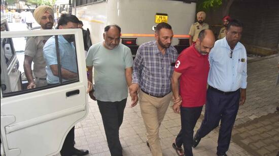 LIT employees being produced in court by the vigilance bureau in Ludhiana. (Gurpreet Singh/HT)