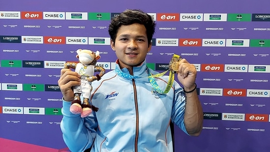 Weightlifter Jeremy Lalrinnunga poses for a photo as he shows off his gold medal he won in the men's 67kg final weight class with a total of 300kg at the 2022 Commonwealth Games in Birmingham .  (ANI Photo)