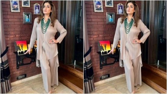 Raveena teamed an ivory white satin long shirt with a pair of trousers with wide legs. The co-ord set featured pleated fabric details all throughout.(Instagram/@officialraveenatandon)