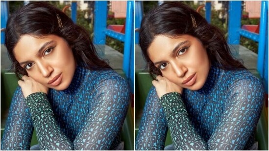 Bhumi wears a blue satin top with turtleneck detail and intricate print with black quirky patterns.  Bhumi paired her top with a pair of blue wide-leg jeans.  (Instagram/@bhumipednekar)