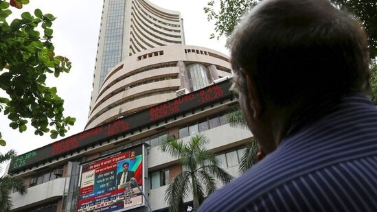 A man looks at a screen across a road displaying the Sensex on the facade of the Bombay Stock Exchange (BSE) building in Mumbai.&nbsp;(Reuters file photo)