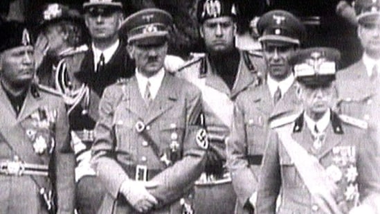 King Victor Emanuel III, Adolf Hitler and Benito Mussolini watch fascist troops march in central Rome in 1941 television file footage. Image via REUTERS