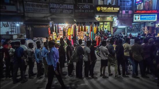 Shops across Delhi on Sunday reported panic buying as buyers joined serpentine queues as uncertainty prevailed over whether private stores will stay open from Monday. (Hindustan Times)