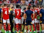 Arsenal head coach Mikel Arteta talks to his players during a cooling break in the first half against Chelsea at Camping World Stadium.