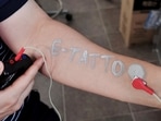 Steve Park, Materials Science & Engineering professor at Korea Advanced Institute of Science and Technology (KAIST), demonstrates an electronic tattoo (e-tattoo) on his arm connected with an electrocardiogram (ECG) monitoring system in Daejeon, South Korea, July 26, 2022. REUTERS/Minwoo Park(REUTERS)