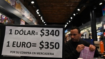 A sign with exchange currency values of the unofficial so-called 'Blue Dollar' --generally quoted at almost double the official rate-- is displayed in the window of a store in Buenos Aires, on August 1, 2022. - Inflation for the first half of this year alone topped 36 percent in Argentina, and is predicted to reach 80 percent by the year's end. (AFP) A sign with exchange currency values of the unofficial so-called 'Blue Dollar' --generally quoted at almost double the official rate-- is displayed in the window of a store in Buenos Aires, on August 1, 2022. - Inflation for the first half of this year alone topped 36 percent in Argentina, and is predicted to reach 80 percent by the year's end. (AFP)