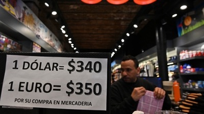 A sign with exchange currency values of the unofficial so-called 'Blue Dollar' --generally quoted at almost double the official rate-- is displayed in the window of a store in Buenos Aires, on August 1, 2022. - Inflation for the first half of this year alone topped 36 percent in Argentina, and is predicted to reach 80 percent by the year's end. (AFP) A sign with exchange currency values of the unofficial so-called 'Blue Dollar' --generally quoted at almost double the official rate-- is displayed in the window of a store in Buenos Aires, on August 1, 2022. - Inflation for the first half of this year alone topped 36 percent in Argentina, and is predicted to reach 80 percent by the year's end. (AFP)
