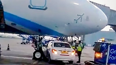 A car belonging to Go First airline stops under an IndiGo A320neo aircraft, narrowly avoiding collision with the plane's nose wheel, at the T2 terminal of IGI Airport in New Delhi on Tuesday, (PTI) A car belonging to Go First airline stops under an IndiGo A320neo aircraft, narrowly avoiding collision with the plane's nose wheel, at the T2 terminal of IGI Airport in New Delhi on Tuesday, (PTI)