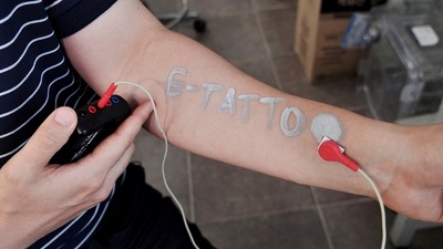 Steve Park, Materials Science & Engineering professor at Korea Advanced Institute of Science and Technology (KAIST), demonstrates an electronic tattoo (e-tattoo) on his arm connected with an electrocardiogram (ECG) monitoring system in Daejeon, South Korea, July 26, 2022.   REUTERS/Minwoo Park (REUTERS)