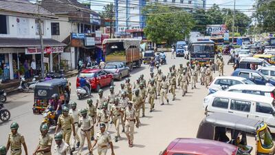 Puttur: Police personnel conduct a march past in Puttur, Mangaluru, Thursday, July 28, 2022. Tension prevailed in Puttur and other talukas of Dakshina Kannada district following the murder of Bharatiya Janata Yuva Morcha (BJYM) member Praveen, who was hacked to death on Tuesday evening, July 26, by unidentified people on a bike. (PTI) Puttur: Police personnel conduct a march past in Puttur, Mangaluru, Thursday, July 28, 2022. Tension prevailed in Puttur and other talukas of Dakshina Kannada district following the murder of Bharatiya Janata Yuva Morcha (BJYM) member Praveen, who was hacked to death on Tuesday evening, July 26, by unidentified people on a bike. (PTI)