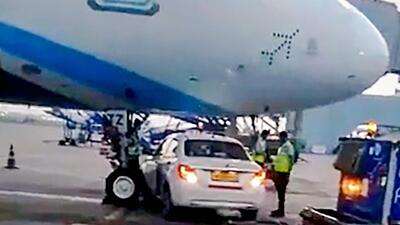 A car belonging to Go First airline under an IndiGo A320neo aircraft, at IGI airport on Tuesday. (PTI) A car belonging to Go First airline under an IndiGo A320neo aircraft, at IGI airport on Tuesday. (PTI)