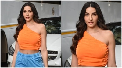 Nora accessorised the ensemble with gold hoop earrings adorned with light blue accents and statement gold rings. Lastly, a centre-parted open hairdo with well-defined wavy ends rounded it all off. (HT Photo/Varinder Chawla) Nora accessorised the ensemble with gold hoop earrings adorned with light blue accents and statement gold rings. Lastly, a centre-parted open hairdo with well-defined wavy ends rounded it all off. (HT Photo/Varinder Chawla)