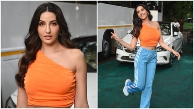 Nora teamed the top with a pair of jogger pants featuring a high-rise waistline, a straight-fit hemline, white stripes on the side, and a bodycon fitting accentuating Nora's curves. In the end, a pair of chunky white lace-up sneakers completed the star's outfit. (HT Photo/Varinder Chawla) Nora teamed the top with a pair of jogger pants featuring a high-rise waistline, a straight-fit hemline, white stripes on the side, and a bodycon fitting accentuating Nora's curves. In the end, a pair of chunky white lace-up sneakers completed the star's outfit. (HT Photo/Varinder Chawla)
