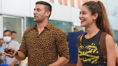 Payal and Sangram posed for pictures for the paparazzi and also interacted with them. They smiled and held each other as they gave different poses for the camera. For her travel, Payal opted for a crop black top and matching tights. Sangram wore a printed shirt and denims. 