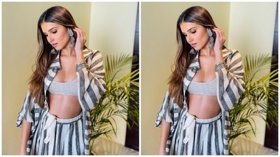Tara chose a grey sports bra featuring a darker striped pattern. It also has a plunging U neckline to flaunt the star's decolletage and a midriff-baring cropped hem. Additionally, she layered a grey oversized collared shirt with dark grey vertical stripes, an open front, flared full sleeves, and drop shoulders on top of the sports bra. (Instagram) Tara chose a grey sports bra featuring a darker striped pattern. It also has a plunging U neckline to flaunt the star's decolletage and a midriff-baring cropped hem. Additionally, she layered a grey oversized collared shirt with dark grey vertical stripes, an open front, flared full sleeves, and drop shoulders on top of the sports bra. (Instagram)