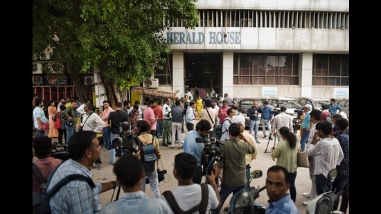 Media personnel gather outside the Herald House amid ED raids in the National Herald money laundering case, in New Delhi on Tuesday. (ANI)