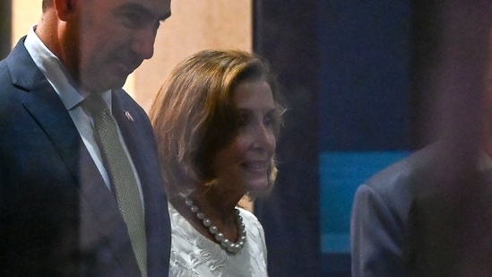 Speaker of the US House of Representatives Nancy Pelosi (R) leaves the Shangri-La Hotel after a reception organised by the American Chamber of Commerce in Singapore.(AFP)