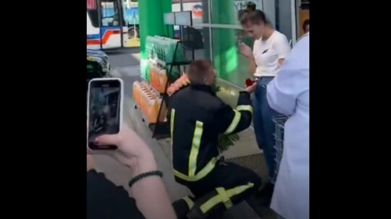 The image, taken from the Twitter video, shows a rescuer proposing to his girlfriend with siren wailing in the background. (Twitter/@Gerashchenko_en)