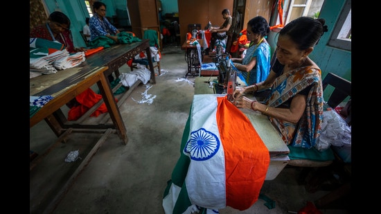Government employees stitch Indian tricolor flags in an office ahead of Independence Day in Gauhati, in the northeastern state of Assam (AP)