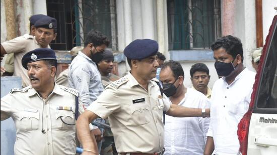 West Bengal police personnel detain three Jharkhand Congress MLAs after a huge amount of cash was found in their vehicle on Saturday, in Howrah district, on Sunday. (PTI)