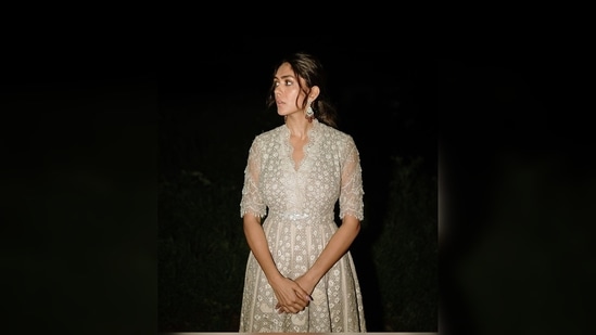 Mrunal Thakur's ivory anarkali set features intricate sequins work all over. The outfit comes with a matching cropped cape.(Instagram/@mrunalthakur)