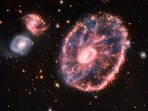 This composite image from Webb's Near-Infrared Camera (NIRCam) and Mid-Infrared Instrument (MIRI) released by NASA on August 2, 2022, shows the Cartwheel and its companion galaxies, revealing details that are difficult to see in the individual images alone. - This galaxy formed as the result of a high-speed collision that occurred about 400 million years ago. The Cartwheel is composed of two rings, a bright inner ring and a colorful outer ring. Both rings expand outward from the center of the collision like shockwaves. This snapshot provides perspective on what happened to the galaxy in the past and what it will do in the future.(AFP)