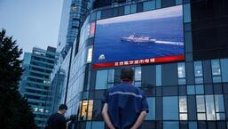 A man watches CCTV news broadcast about joint military operations near Taiwan by the Chinese People's Liberation Army (PLA) Eastern Theater Command at a shopping center in Beijing on Wednesday.  (Reuters)