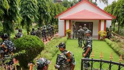 CRPF personnel stand guard during a raid by ED sleuths at the premises of Arpita Mukherjee and suspended TMC leader Partha Chatterjee's joint bungalow, at Santiniketan in Birbhum district on Wednesday. (PTI) CRPF personnel stand guard during a raid by ED sleuths at the premises of Arpita Mukherjee and suspended TMC leader Partha Chatterjee's joint bungalow, at Santiniketan in Birbhum district on Wednesday. (PTI)