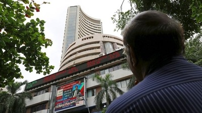 A man looks at a screen across a road displaying the Sensex on the facade of the Bombay Stock Exchange (BSE) building in Mumbai, India. (File image) (REUTERS)