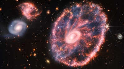 This composite image from Webb's Near-Infrared Camera (NIRCam) and Mid-Infrared Instrument (MIRI) released by NASA on August 2, 2022, shows the Cartwheel and its companion galaxies, revealing details that are difficult to see in the individual images alone. - This galaxy formed as the result of a high-speed collision that occurred about 400 million years ago. The Cartwheel is composed of two rings, a bright inner ring and a colorful outer ring. Both rings expand outward from the center of the collision like shockwaves. This snapshot provides perspective on what happened to the galaxy in the past and what it will do in the future. (AFP) This composite image from Webb's Near-Infrared Camera (NIRCam) and Mid-Infrared Instrument (MIRI) released by NASA on August 2, 2022, shows the Cartwheel and its companion galaxies, revealing details that are difficult to see in the individual images alone. - This galaxy formed as the result of a high-speed collision that occurred about 400 million years ago. The Cartwheel is composed of two rings, a bright inner ring and a colorful outer ring. Both rings expand outward from the center of the collision like shockwaves. This snapshot provides perspective on what happened to the galaxy in the past and what it will do in the future. (AFP)