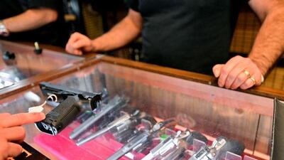 A customer at Wanstall's Hunting & Shooting looks at a handgun after Canada's government introduced legislation to implement a "national freeze" on the sale and purchase of handguns, as part of a gun control package that would also limit magazine capacities and ban some toys that look like guns, in Maple Ridge, British Columbia, Canada in May. (REUTERS)
