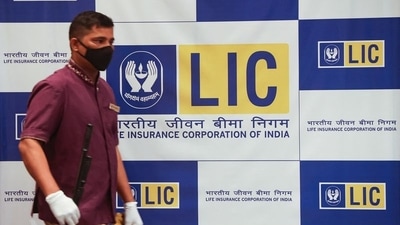 A man walks past a hoarding of Life Insurance Corporation of India (LIC) in Mumbai. (REUTERS file)