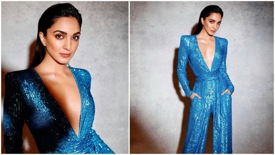 Kiara Advani is looking jaw-dropping gorgeous in a blue shimmery jumpsuit with pockets and a belt. She completed the look with sleek hairstyle and glossy nude make up. Her sequined attire featured power shoulders that extended to long loose sleeves and a plunging V-shaped neckline.&nbsp;(Instagram)