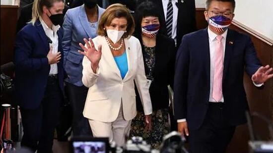 Nancy Pelosi walks next to Legislative Yuan Vice President Tsai Chi-chang as she leaves the parliament in Taipei. (Agency)
