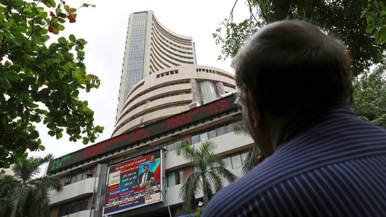 A man looks across the road at a screen displaying the Sensex in front of the Bombay Stock Exchange (BSE) building in Mumbai, India.  (File photo) (REUTERS)