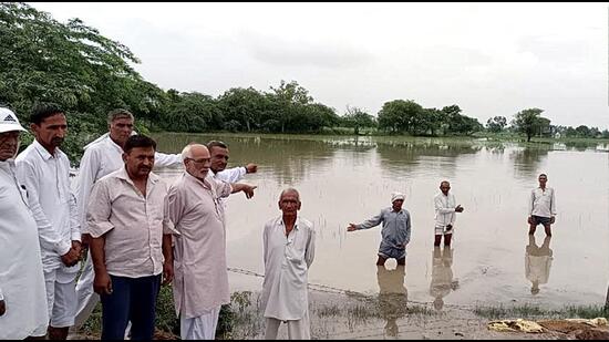 Farmers showing submerged crops at a village in Rohtak on Wednesday. (Manoj Dhaka/HT)