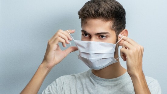 Do: Cover your mouth with a mask and hands with disposable gloves near the patient. (Unsplash)
