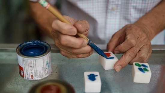 Hand carving playing tiles for the popular Chinese game used to be a source of income for many, but the introduction of much cheaper machine-made sets whittled away at their customer base and turned their work into a rarity. (AFP)