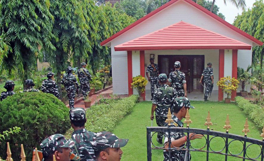 CRPF personnel stand guard outside the farmhouse, which was allegedly purchased by former West Bengal minister Partha Chatterjee and his aide, Arpita Mukherjee as ED officials searched the premises, at Bolpur subdivision of Birbhum district on Wednesday. (ANI) CRPF personnel stand guard outside the farmhouse, which was allegedly purchased by former West Bengal minister Partha Chatterjee and his aide, Arpita Mukherjee as ED officials searched the premises, at Bolpur subdivision of Birbhum district on Wednesday. (ANI)