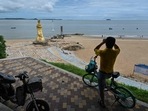 A man looks through a pair of binoculars in Xiamen, across Taiwan's Kinmen Islands on August 3, 2022. A man looks through a pair of binoculars in Xiamen, across Taiwan's Kinmen Islands on August 3, 2022.