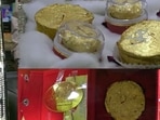 The image shows the ghevar prepared by a sweet shop in Agra. It is topped with 24-carat gold. (Twitter/@AHindinews) The image shows the ghevar prepared by a sweet shop in Agra. It is topped with 24-carat gold. (Twitter/@AHindinews)
