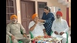 Gurdeep Singh’s father Bhag Singh (centre) and other family members celebrate with sweets as they watch the repeat telecast of his stellar performance, in Majri village in Khanna on Thursday. (HT Photo) Gurdeep Singh’s father Bhag Singh (centre) and other family members celebrate with sweets as they watch the repeat telecast of his stellar performance, in Majri village in Khanna on Thursday. (HT Photo)