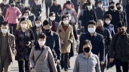 FILE PHOTO: People wearing protective face masks commute amid concerns over the new coronavirus disease (COVID-19) in Pyongyang, North Korea.